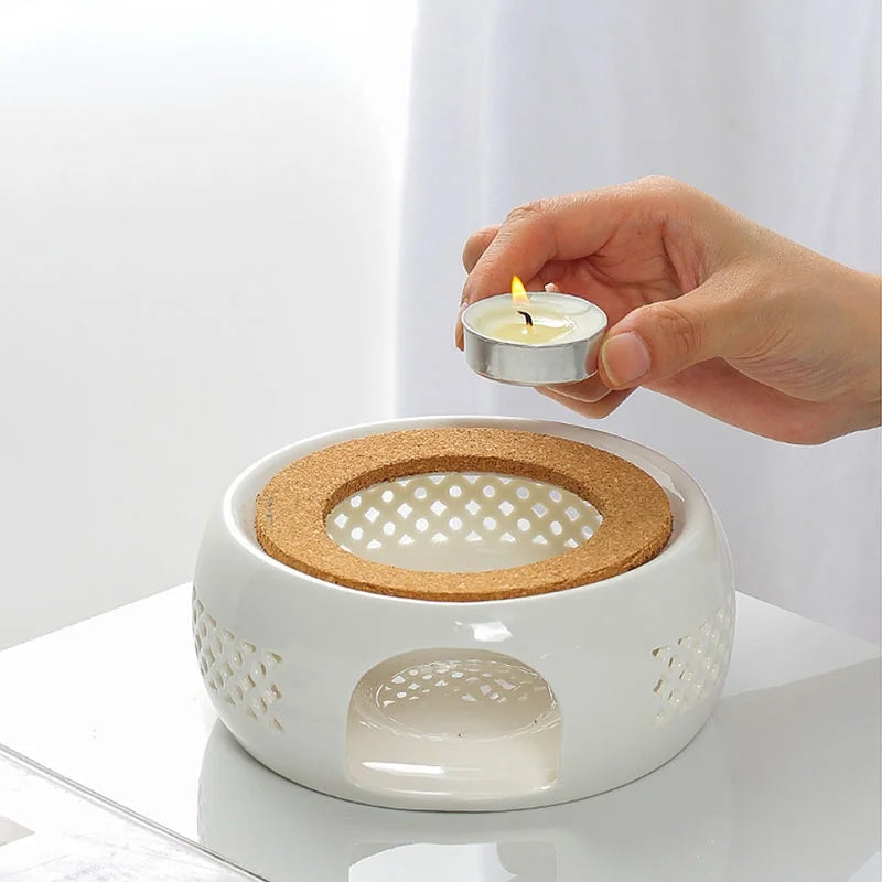 White ceramic teapot warmer with natural cork base, front view