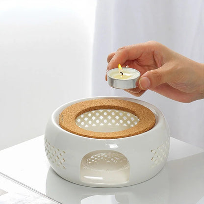 White ceramic teapot warmer with natural cork base, front view