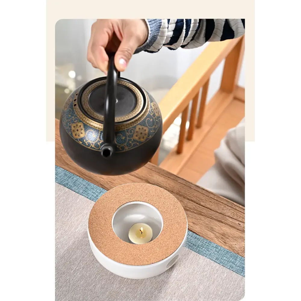 White ceramic teapot warmer with cork base close up