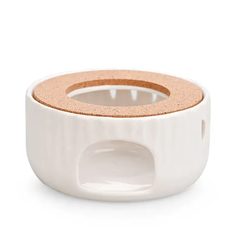 Ceramic teapot warmer with cork base placed on wooden table, lifestyle shot