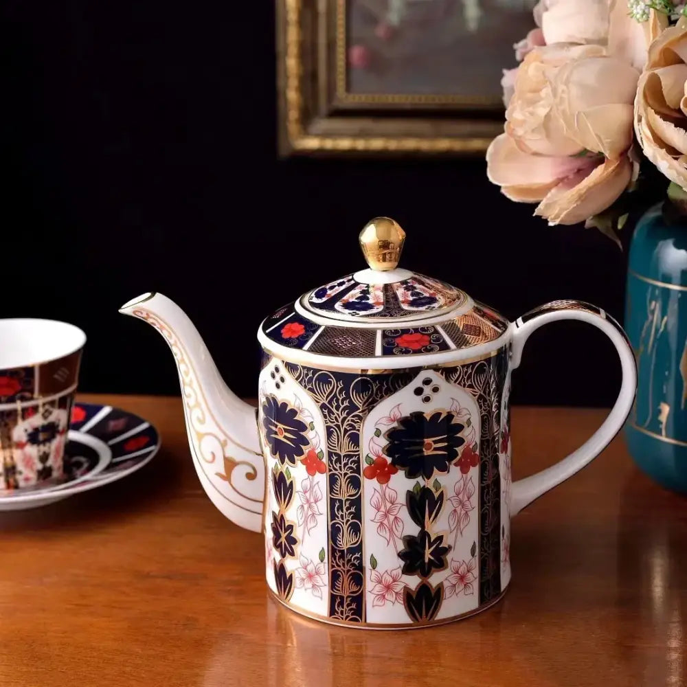 Ceramic teapot with floral motifs in blue and red