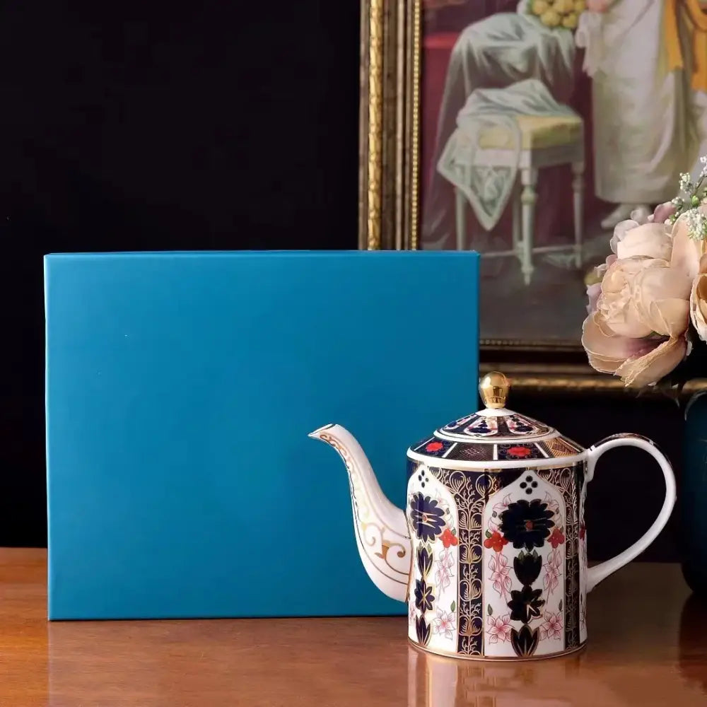 Ceramic teapot with floral design and lid