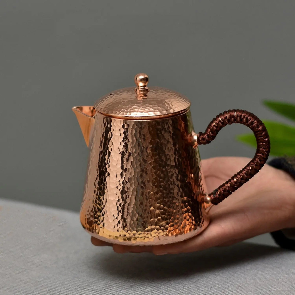 Handcrafted Chinese copper teapot 500ml on wooden table, full silhouette