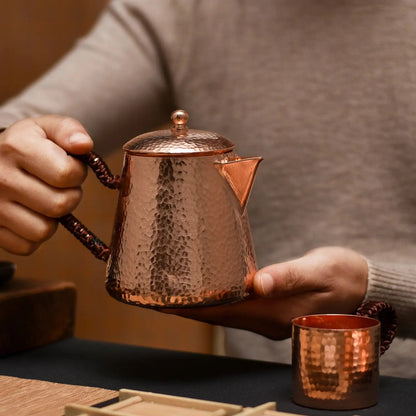 Close-up of handcrafted copper teapot showing hammer-textured surface