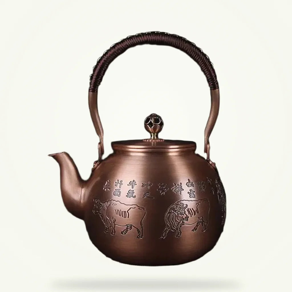 Handcrafted Chinese copper teapot with bull motif, 1.5 L, on plain background