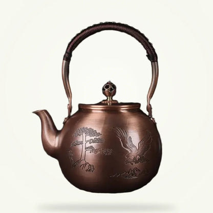 Chinese copper teapot with hand-engraved eagle motif, 1.5L, front view on plain background