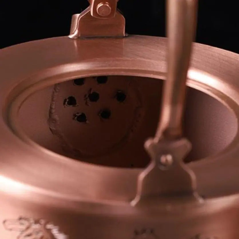 Side angle of engraved copper teapot showing full horse motif detail, 1L capacity