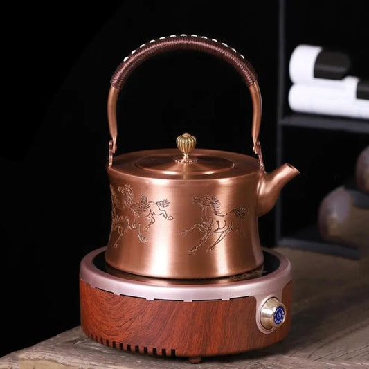 Top view of Chinese copper teapot showing engraved horse design on lid and body