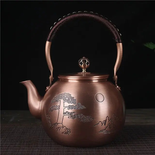 Hand-engraved full moon design on Chinese copper teapot, close-up detail