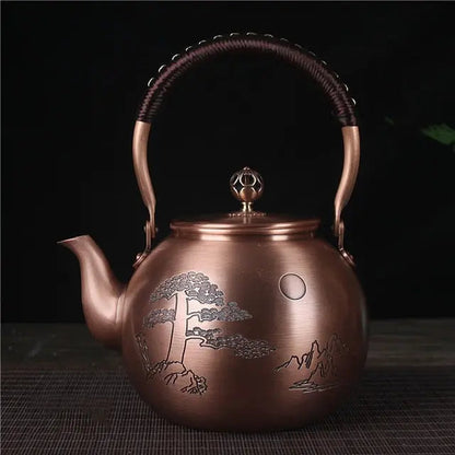 Hand-engraved full moon design on Chinese copper teapot, close-up detail