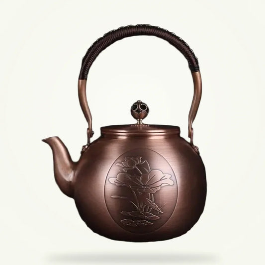 Chinese copper teapot with water lily motif 1.5L, front view on plain background
