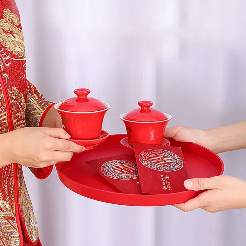 Red Chinese tea tray with teapot and cups