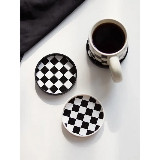 Coffee saucer with mug on wooden table