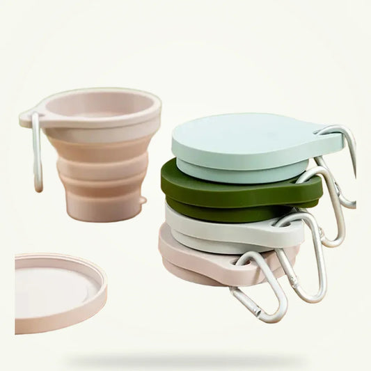 Collapsible silicone travel tea cup set of 2 on plain background, green color