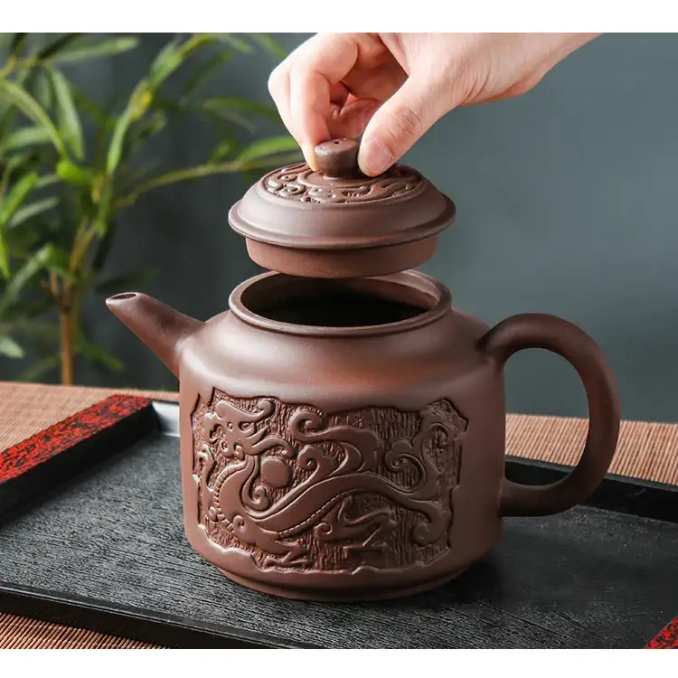 Ceramic teapot with steam rising from spout