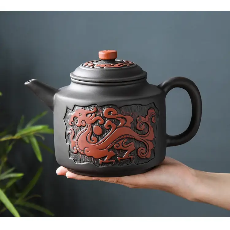 Ceramic teapot with tea leaves and infuser