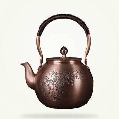 Handcrafted copper Chinese teapot with engraved leaf motif, 1.5L, front view on plain background