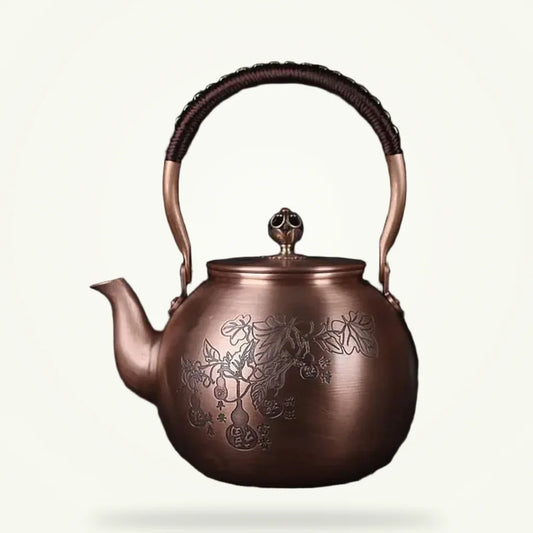 Handcrafted copper Chinese teapot with engraved leaf motif, 1.5L, front view on plain background