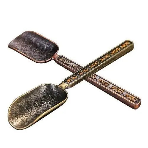 Copper tea spoon on a saucer