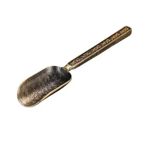Copper tea spoon yellow background