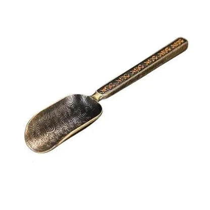 Copper tea spoon yellow background