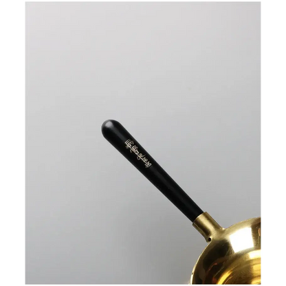 Copper tea strainer with tea leaves in mesh