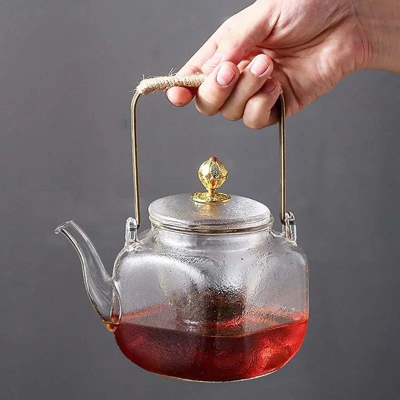 Close-up of curved spout and lid on handcrafted copper teapot