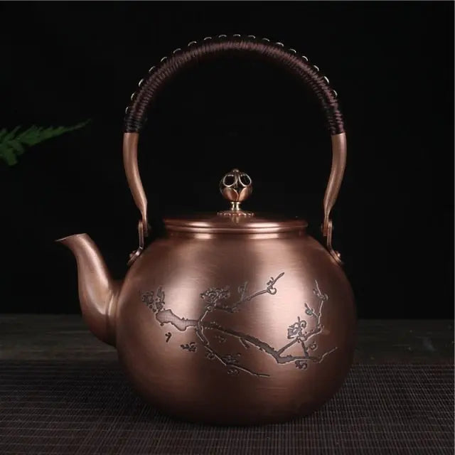 Round Chinese-style copper cherry blossom teapot 1.5L, side angle showing engraved motif detail