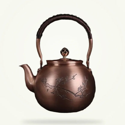 Copper teapot with hand-engraved cherry blossom motif, 1.5L, front view on plain background