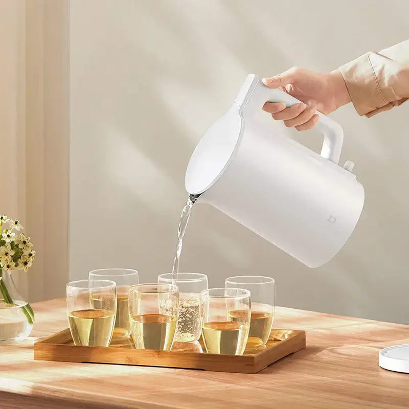 Stainless steel cordless electric kettle 1.5L sitting on 360-degree swivel base