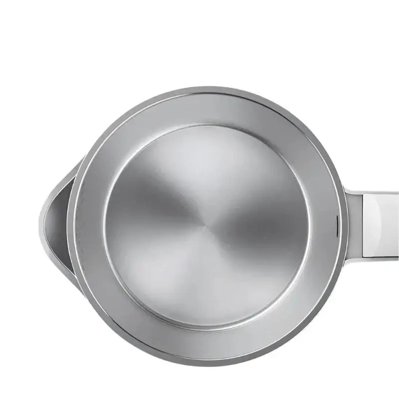 Steam rising from spout of stainless steel cordless kettle at full boil