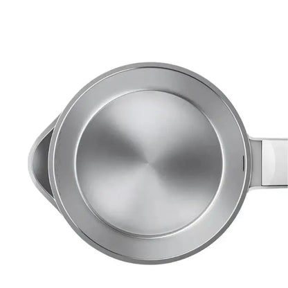 Steam rising from spout of stainless steel cordless kettle at full boil