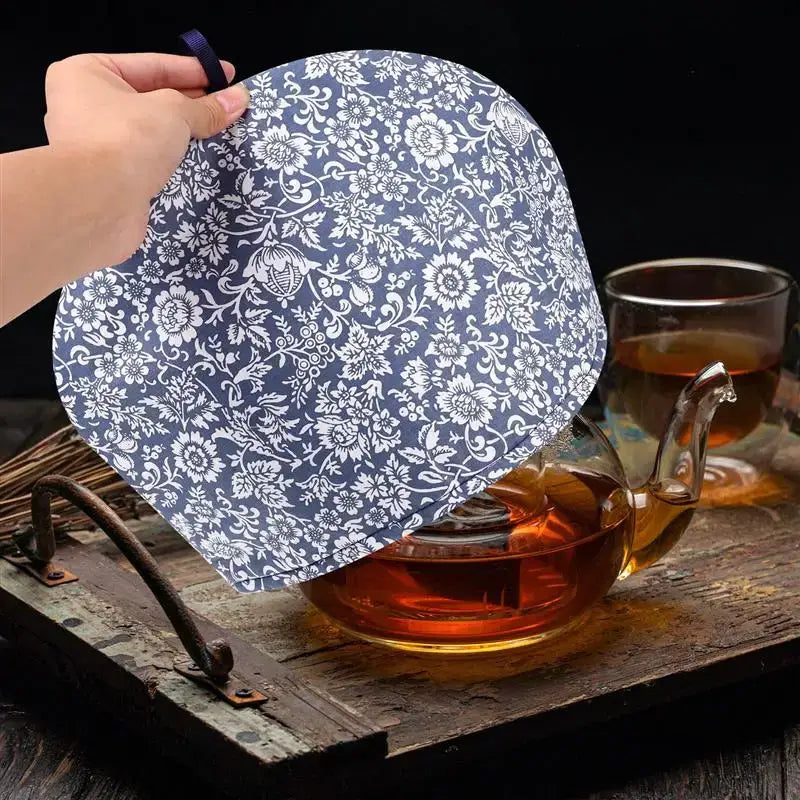 Blue cotton insulated teapot cozy laid flat, showing color and weave detail