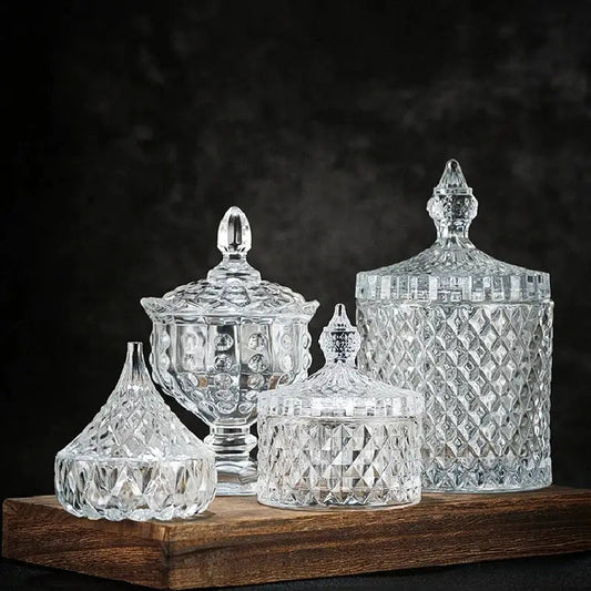 Crystal glass tea storage jar with lid on kitchen counter beside loose leaf tea