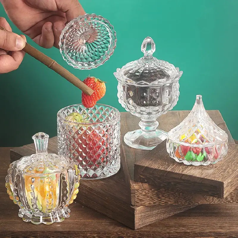 Crystal glass tea jars with lids displayed with assorted loose leaf teas