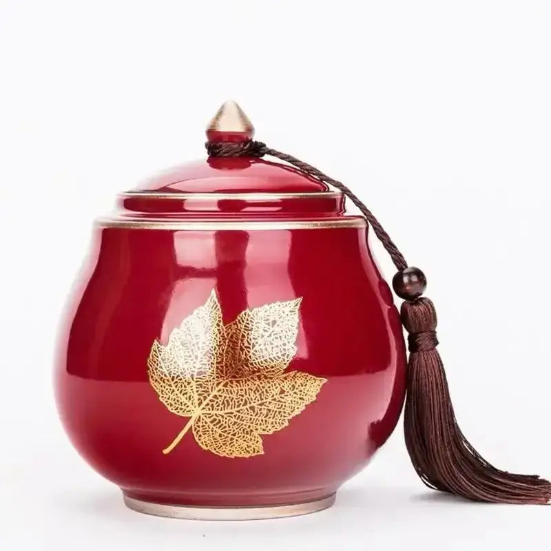 Dark red glazed ceramic tea canister with airtight lid, hand-painted finish