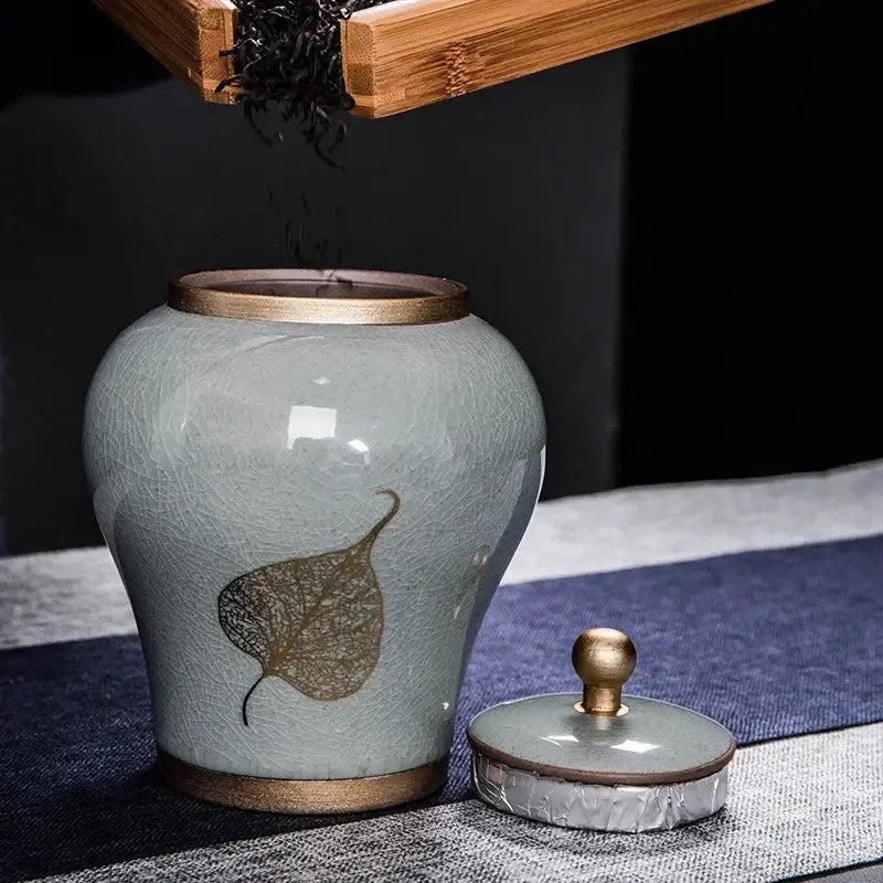 Autumn red ceramic tea canister with botanical leaf design and fitted lid