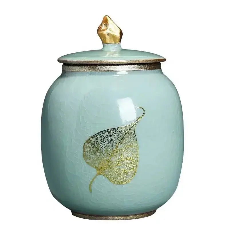 Blue ceramic tea canister with airtight lid displayed on open kitchen shelf