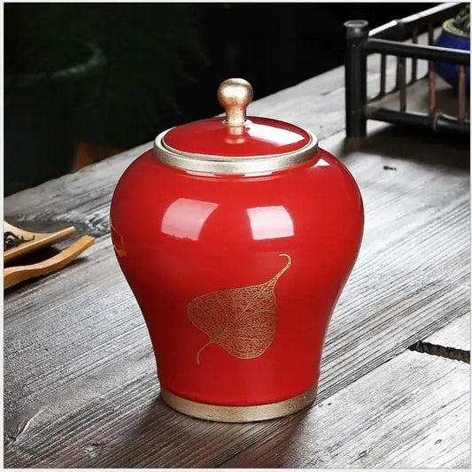 Red leaf pattern ceramic tea canister with fitted airtight lid, front view