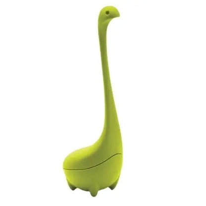 Green diplodocus tea infuser steeping inside a ceramic mug