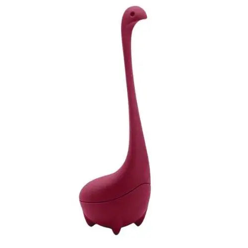 Pink dinosaur tea infuser with loose leaf tea leaves inside