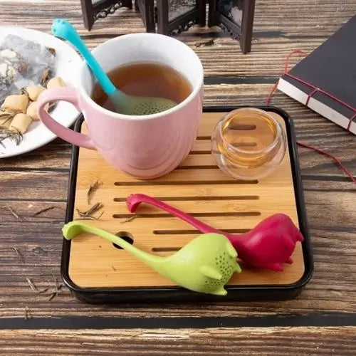 Dinosaur tea infuser being filled with loose leaf tea before steeping