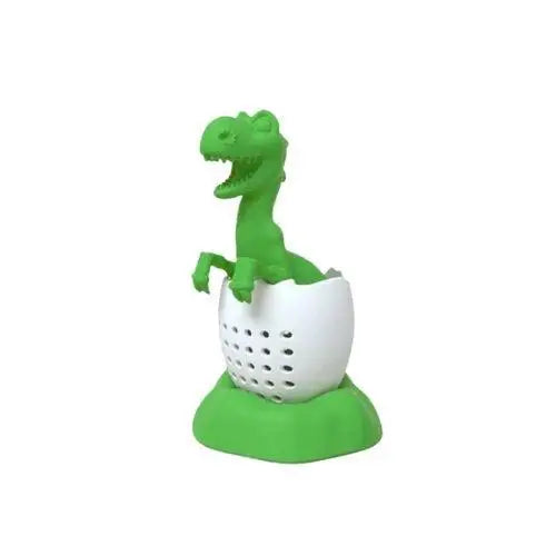 Green dinosaur tea strainer on a white cup ready to steep