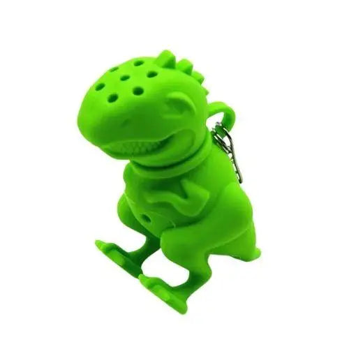 Green dinosaur silicone loose leaf tea infuser sitting on mug rim