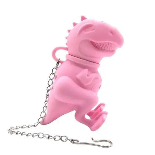 Pink dinosaur silicone tea infuser for loose leaf tea on white mug