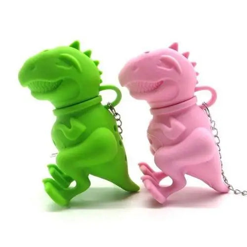 Dinosaur silicone tea infuser with steam rising from hot cup of tea