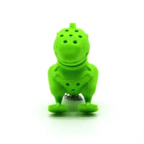 Dinosaur tea infuser shown alongside loose leaf tea on wooden surface