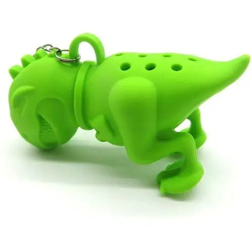 Green and pink dinosaur tea infusers resting on ceramic saucer