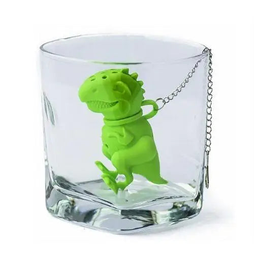 Green dinosaur silicone infuser after steeping tea, ready to rinse