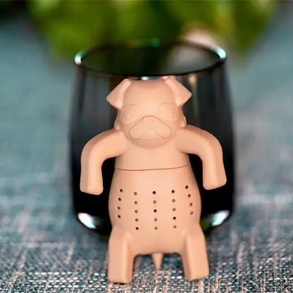 Beige dog tea infuser sitting in a white mug